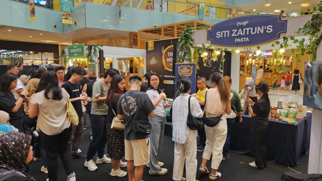 Members of the audience queueing to sample the finalists’ dishes before casting their votes.